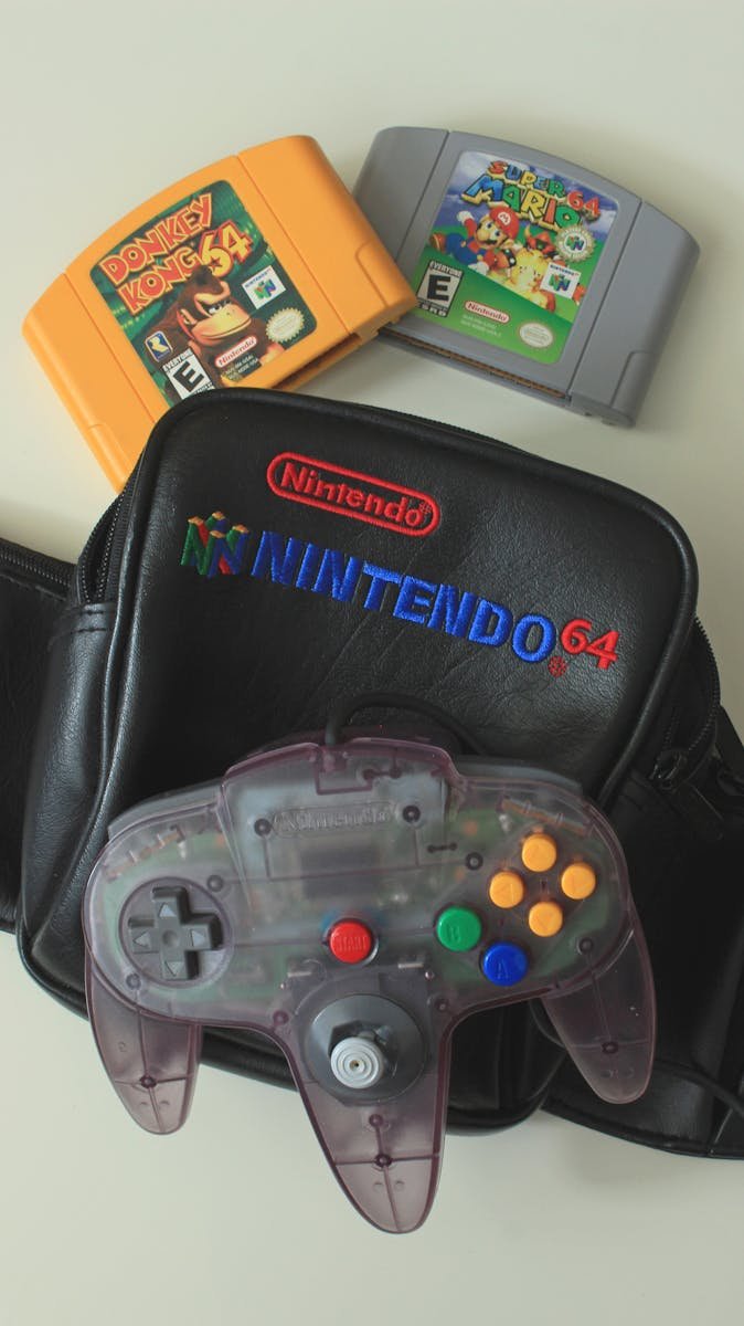 Vintage Nintendo 64 controller with game cartridges on a retro gaming bag.