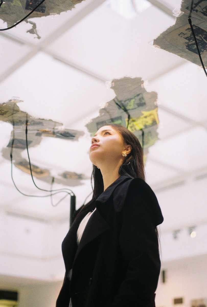Woman looking up at an art installation